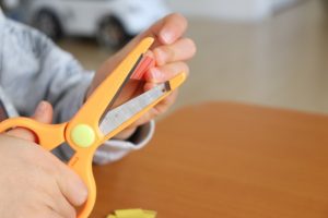 ハサミで切り紙をする子ども