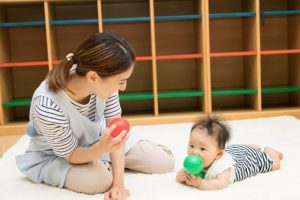 0歳児と遊ぶ保育士